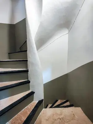 a staircase in a house with a white ceiling at Le Mistral Studio au cœur du centre historique in Aix-en-Provence
