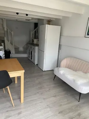 a living room with a table and a refrigerator at Studio 1 personne Vaucluse in Carpentras