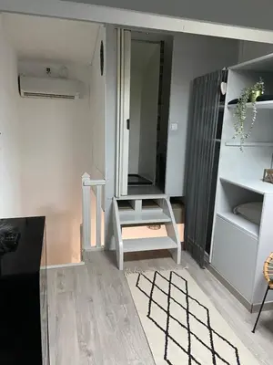a living room with a chair and a mirror at Studio 1 personne Vaucluse in Carpentras