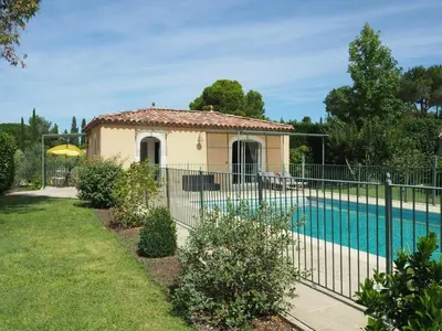 a house with a fence around a swimming pool at Charming Holiday Villa with Pool in LʼIsle-sur-la-Sorgue
