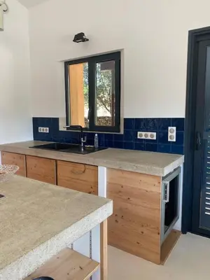 a kitchen with a sink and a counter with a mirror at Le Jardin des Graminées in Cabrières-dʼAvignon