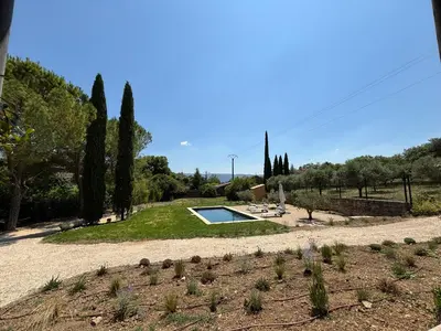 a garden with a swimming pool in the middle at Le Jardin des Graminées in Cabrières-dʼAvignon