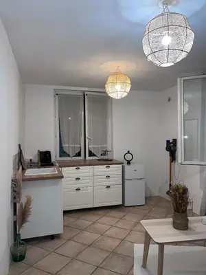 a kitchen with white cabinets and two lights at 2 rooms very well located in L'Isle-sur-la-Sorgue in LʼIsle-sur-la-Sorgue