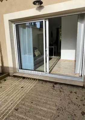 a sliding glass door with a couch inside of it at Le studio de Marie in Noves