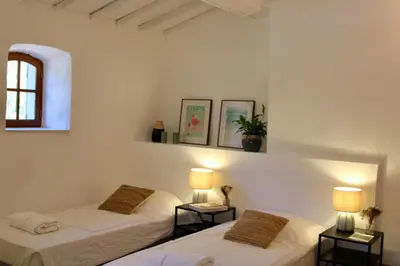 two beds in a room with two lamps at Quiet Provencal bastide with pool close Lourmarin in Lauris