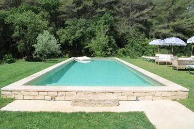 a swimming pool in the middle of a yard at Quiet Provencal bastide with pool close Lourmarin in Lauris