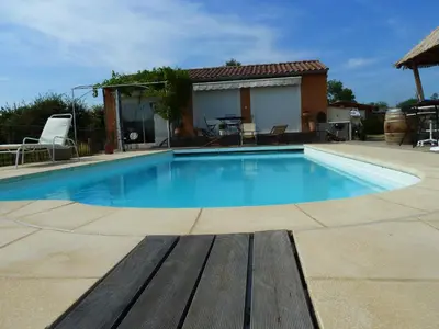 a swimming pool in a yard with a house at Iris Caromb in Caromb