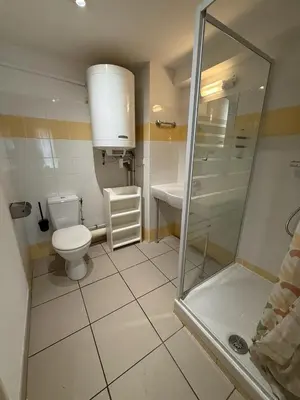 a small bathroom with a toilet and a shower at Le Clos D'AIX Studio 108 in Aix-en-Provence