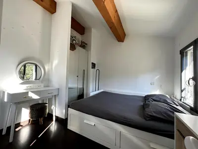 a bedroom with a bed and a desk and a window at 3 bedroom villa with pool in Aix-en-Provence