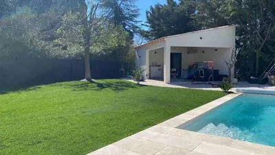 a backyard with a swimming pool and a house at 3 bedroom villa with pool in Aix-en-Provence