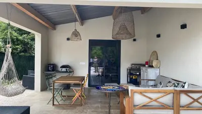 a patio with a table and a kitchen with a table at 3 bedroom villa with pool in Aix-en-Provence