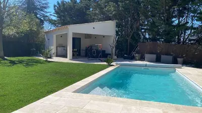 a swimming pool in a yard next to a house at 3 bedroom villa with pool in Aix-en-Provence