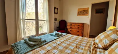 a bedroom with a bed and a window and a dresser at Spacious apartment 4 people parking, bright in Aix-en-Provence