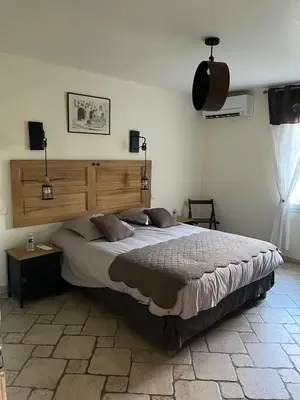a bedroom with a large bed in a room at Maison d'hôte en Provence avec petit déjeuner in Mollégès
