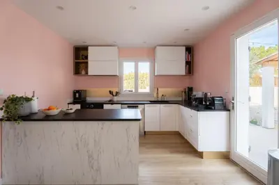 a kitchen with white cabinets and black counter tops at Olyma - Spacieuse - Familiale - Piscine & Climatisé in Éguilles