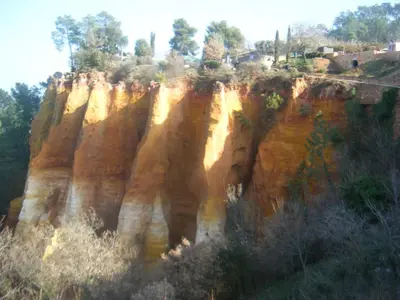 a rocky cliff with trees on top of it at Roussillon House in Roussillon