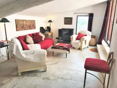 a living room with two couches and a tv at Roussillon House in Roussillon