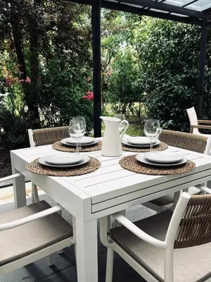 a white table with plates and glasses on a patio at Casa Regina - Spacieux appartement près de la Sorgue in LʼIsle-sur-la-Sorgue