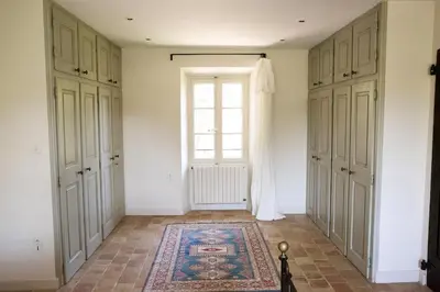 an empty room with a window and a rug at Le mas provençal d'Aurélie in Carpentras