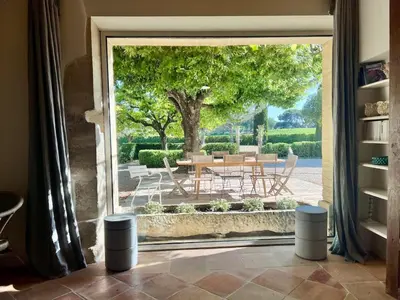 an open door to a patio with a table and chairs at Le mas provençal d'Aurélie in Carpentras