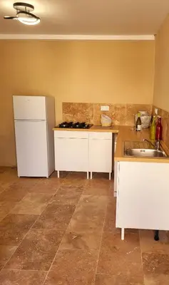 a kitchen with a white refrigerator and a sink at L'Orée du Ventoux - Crillon-le-Brave in Crillon-le-Brave