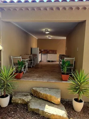 a living room with plants and a kitchen and a table at L'Orée du Ventoux - Crillon-le-Brave in Crillon-le-Brave