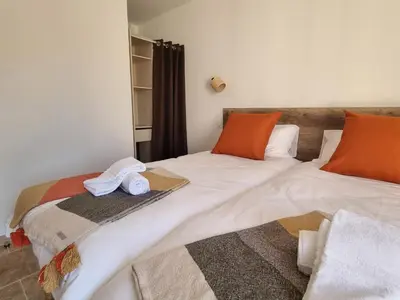 two beds sitting next to each other in a room at L'Orée du Ventoux - Crillon-le-Brave in Crillon-le-Brave