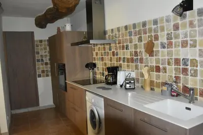 a kitchen with a sink and a washing machine at Gite chez les Truph in Entraigues-sur-la-Sorgue