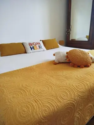 a stuffed animal sitting on top of a bed at Villa MOOREA pool barbecue PROVENCE in Entraigues-sur-la-Sorgue