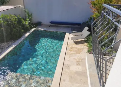 a small swimming pool with blue water in a backyard at Villa MOOREA pool barbecue PROVENCE in Entraigues-sur-la-Sorgue