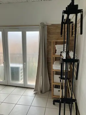 a room with sliding glass doors and a shelf with towels at Maison de village à Pertuis in Pertuis