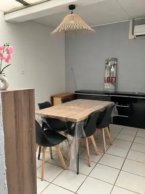 a dining room with a wooden table and chairs at Maison de village à Pertuis in Pertuis