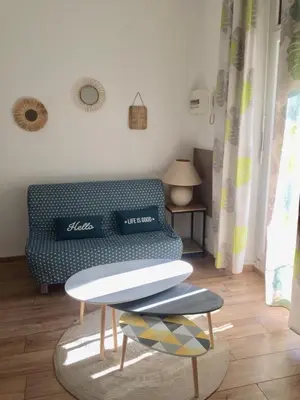 a living room with a couch and a table at Appartement T2 Centre in Carpentras