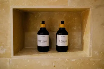 two bottles of wine sitting in a box at AMA, suite avec baignoire balnéo et sauna privé in Avignon