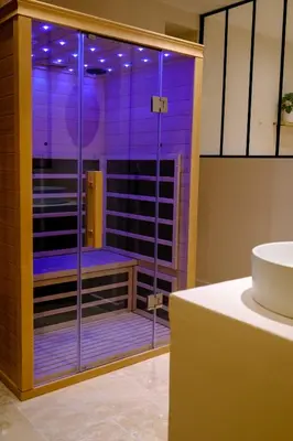 a bathroom with a shower with purple lighting at AMA, suite avec baignoire balnéo et sauna privé in Avignon