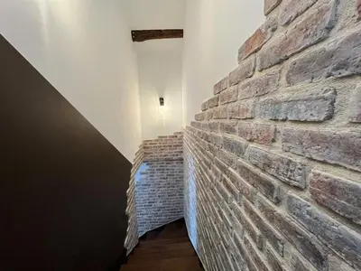 a brick wall in a room with a hallway at Duplex Factory II Hyper Centre in Salon-de-Provence