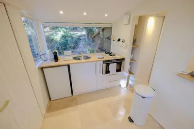 a small kitchen with a sink and a window at L'intimiste in Aix-en-Provence