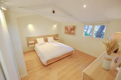 a bedroom with a white bed and a window at L'intimiste in Aix-en-Provence