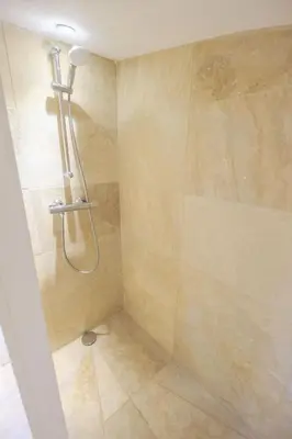 a shower with a shower head in a bathroom at L'intimiste in Aix-en-Provence