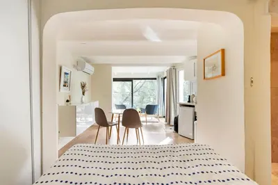 a bedroom with a bed and two chairs and a table at Le Dandy in Aix-en-Provence