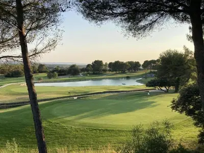 a view of a golf course with a lake at Appartement Nature Golf de Saumane - Vue & Calme in Saumane-de-Vaucluse