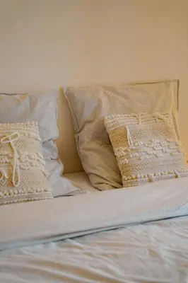 a bed with two pillows on top of it at Appartement Nature Golf de Saumane - Vue & Calme in Saumane-de-Vaucluse