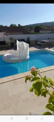 a white object is sitting on top of a swimming pool at Villa tout confort en Provence avec Piscine, ainsi qu'un parking privé in Manosque