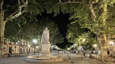 a statue in the middle of a street at night at Loft in hôtel particulier, city-center, air conditioned in Aix-en-Provence
