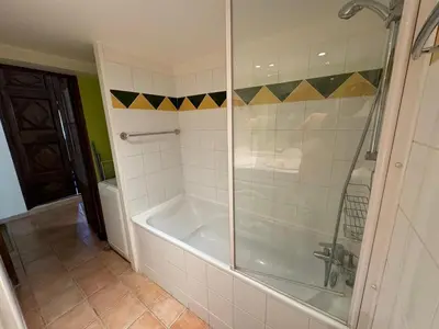 a bathroom with a shower and a bath tub at Loft in hôtel particulier, city-center, air conditioned in Aix-en-Provence