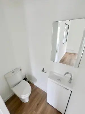 a white bathroom with a toilet and a mirror at Charmant appartement indépendant in Cavaillon