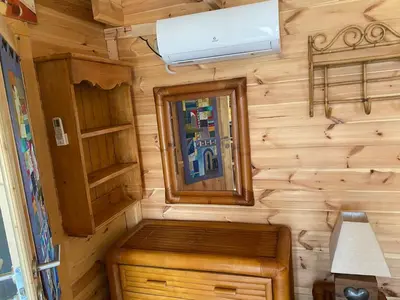 a tiny house with a window and a mirror at Cabane bambou in Apt