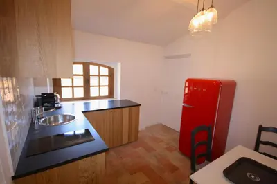 a kitchen with a red refrigerator and a sink at Appartement Quartier Mazarin in Aix-en-Provence