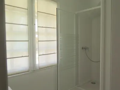 a bathroom with a shower with a glass door at Appartement Quartier Mazarin in Aix-en-Provence