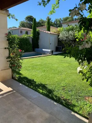 a yard with a lawn with a bench in it at Mas Rémy-Villa in private residence in Saint-Rémy-de-Provence